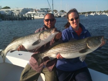 New Hampshire couple on Hairball Charters with trophy striped bass off cape cod
